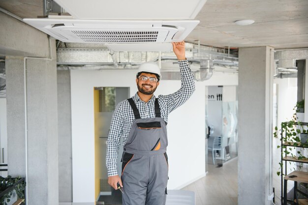professional-technician-maintaining-modern-air-conditioner-indoors-space-text
