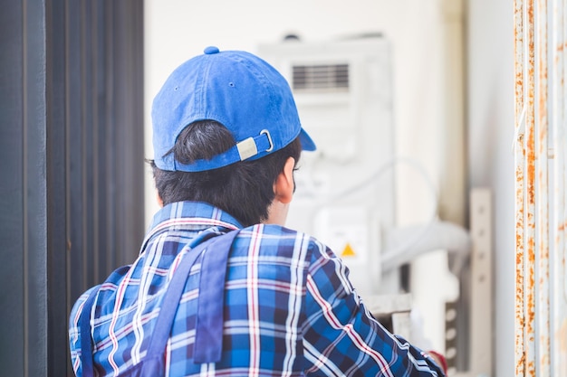 rear-view-repairman-fixing-air-conditioner-unit-technician-man-installing-air-conditioning-client-house-maintenance-repairing-concepts